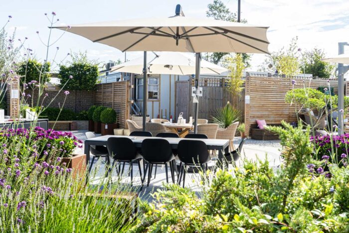 table and chairs laid out on a sunny day in the engish garden.